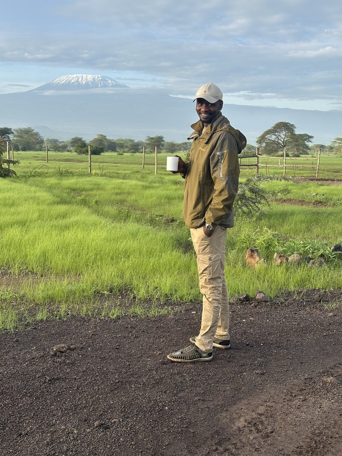 Alvin, the safari guide, smiling warmly in his field gear.
